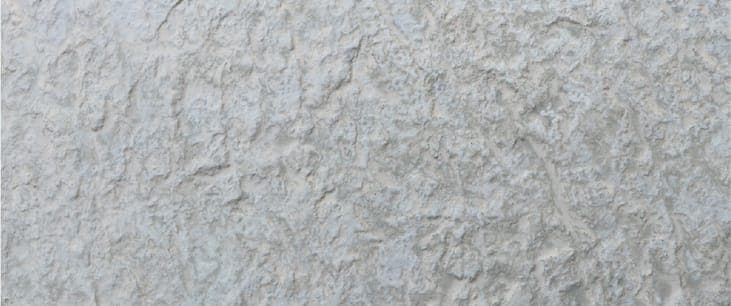 Rockface Stone flexible clay cladding — raw split rock, three tones